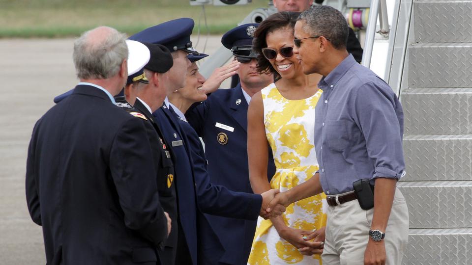 Cheers, sighs over Obamas' visit