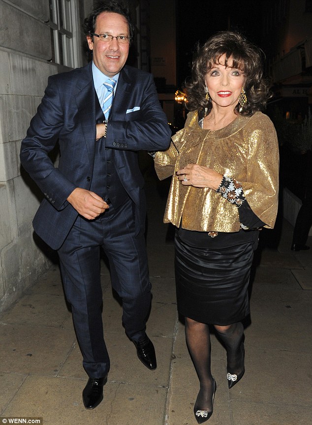 Joan Collins looks glamorous in gold as she enjoys date night with husband Percy