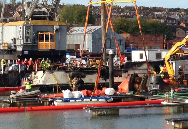 Huge crane raises destroyed luxury motorboat Kahu, from seabed