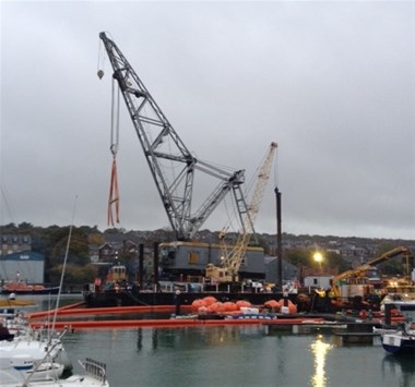 Blackened wreck of superyacht lifted from marina