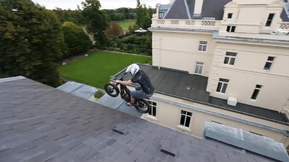 Daredevil biker jumps between ledges on roof of abandoned £100m mansion