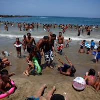 Protest-weary Venezuelans take politics to the beach