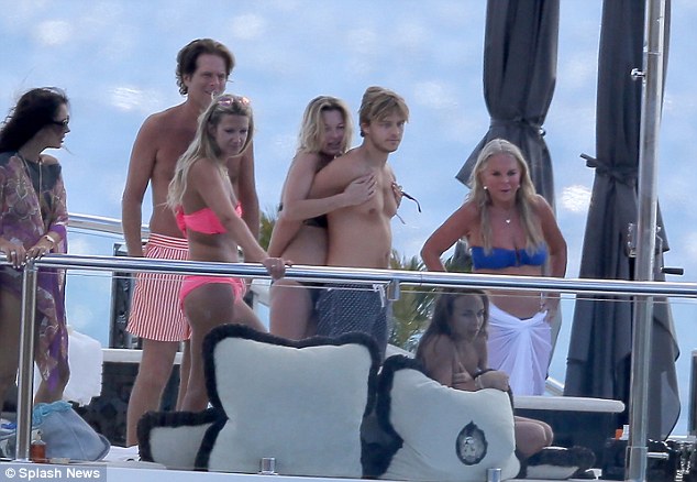 Bikini-clad Kate Moss hugs holiday companion as she suns herself on Phillip …