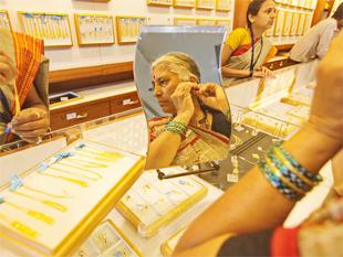 Gold ends lower on subdued demand; silver strengthens