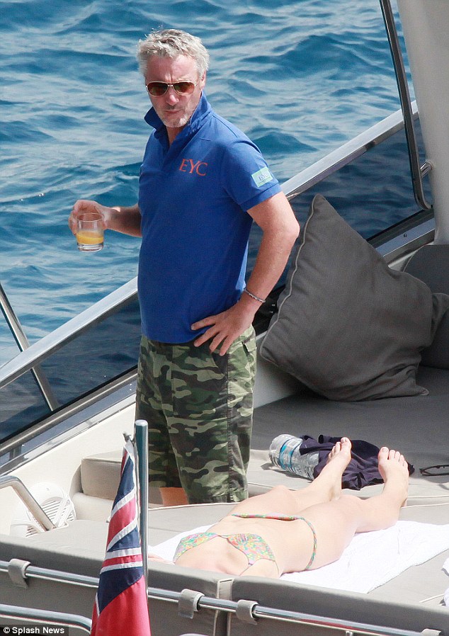 Former Formula One driver Eddie Irvine is surrounded by bikini clad beauties …