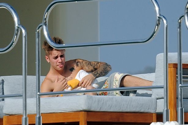 Topless Justin Bieber looks worse for wear on luxury yacht after inviting …