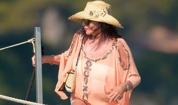 Joan Collins wears sheer cover-up in St Tropez