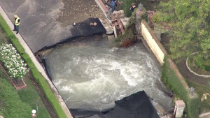 Water Main Break Leaves Pool of Water Swirling Beneath Street in Encino