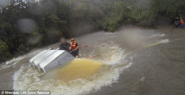 The dramatic moment three people were winched to safety from the roof of their …