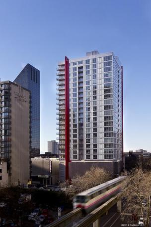 Invesco strikes again with $114M purchase of Vulcan apartment tower